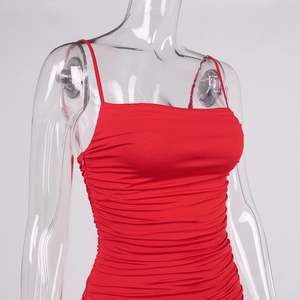 Detailed front view of red ruched bodycon dress featuring thin straps and pleated fabric