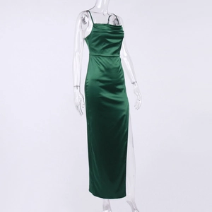 Detail of emerald green satin dress featuring a cowl neck and high side slit design