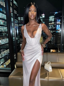 Detail of elegant champagne satin evening dress with deep V-neck and high side slit
