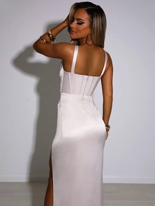 Detail of elegant champagne white satin long dress featuring high side slit and open back
