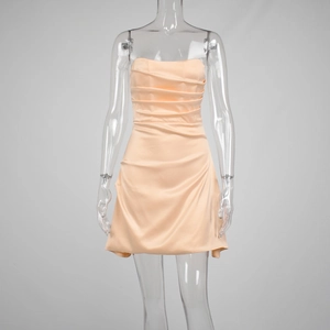 Detailed view of apricot satin mini dress with horizontal ruching and strapless neckline