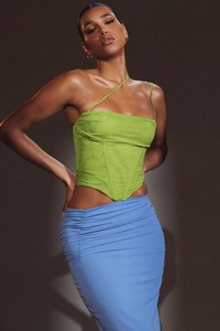 Detail of green mesh corset top with boning and ruched light blue maxi skirt