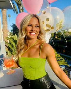 Detail of lime green corset top with boning structure shown in an outdoor party setting