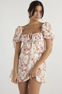 Detailed view of floral A-line dress with puff sleeves and lace-up ribbon accents