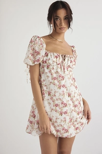 Detail of floral mini dress featuring puff sleeves and retro pink rose pattern