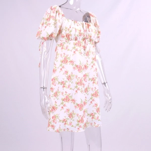 Detailed view of the square neckline and puff sleeves on the floral summer dress