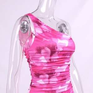 Close-up of pink tie-dye ruched dress with one-shoulder detail and stretch fabric texture