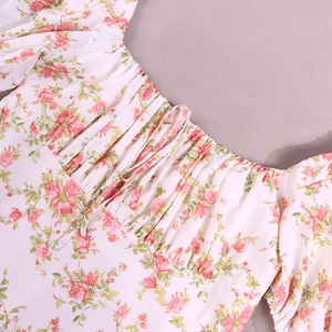 Detailed view of puff sleeve dress featuring floral rose patterns and drawstring neckline
