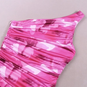 Detail view of pink dye print dress showing invisible side zipper and ruched shoulder seams