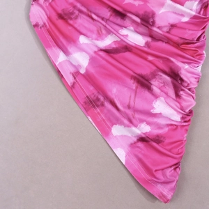 Detail of fuchsia and purple marble print dress featuring side ruching and neat hemline