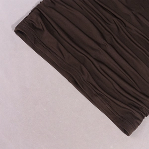 Detail view of coffee brown bodycon dress showing ruched fabric and double stitched hem