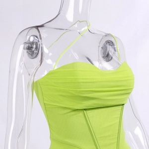 Detail of neon green mesh corset top featuring pleated chest and boning structure