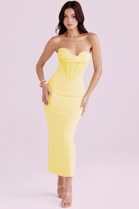 Detail of a bright yellow corset dress featuring a boned bodice and elegant open shoulder