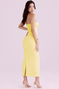 Detail of yellow backless dress with corset boning and a high back slit design