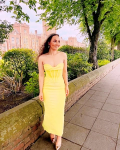 Elegant bright yellow strapless corset maxi dress with a slimming fishtail silhouette