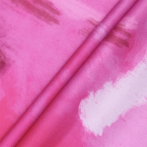 Detail of vibrant rose red abstract print fabric with sophisticated pleated draping