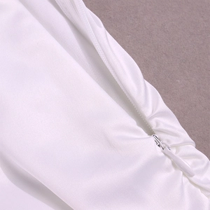 Detail of invisible teardrop zipper on elegant white satin dress with smooth texture