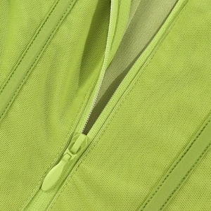 Close-up of fluorescent green mesh fabric and matching hidden resin zipper details