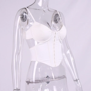 Detail of white corset top featuring heart-shaped neckline, boning and front button closure