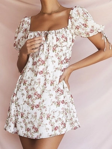 Women's white floral mini dress with puff sleeves and red rose pattern, open back design