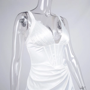 Detail of white satin dress featuring v-neckline with boning corset and pleated bust