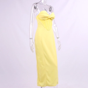 Detail of light yellow strapless maxi dress featuring a structured corset boning waist