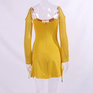 Detail of yellow mini dress with long mesh sleeves and side drawstring bullet accents