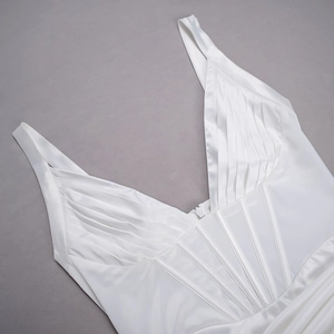 Detailed view of white satin dress featuring deep V-neckline and corset style boning