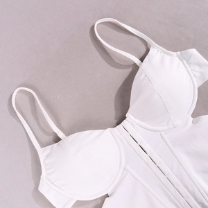 Close-up of white corset top with supportive boning structure and thin shoulder straps