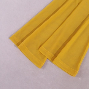 Detail of sheer yellow mesh fabric with high-quality double-stitched hem and fine texture