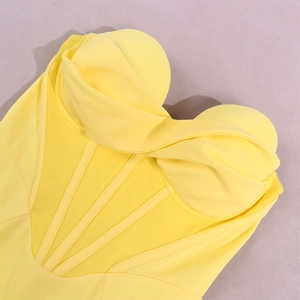 Detail of yellow boned corset dress with pleated padded cups and sheer mesh panels