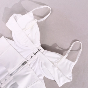 Detail of white corset top featuring metal hook-and-eye closure and bottom zipper