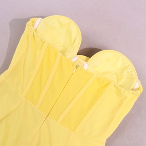 Detail of yellow sweetheart corset dress featuring structured boning and a back zipper