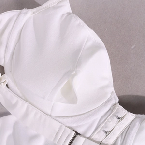 Close-up of white vest detailing inner padding slots and adjustable metal hook closure