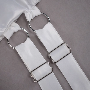 Detail of adjustable white satin strap with silver metal ring and slider buckle