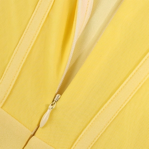 Macro detail of high-quality invisible zipper and fine stitching on yellow corset dress