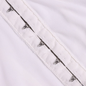 Close-up of secure silver hook-and-eye closure on white corset crop top fabric
