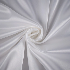 Detail of high-quality white satin fabric with smooth texture and soft pearly luster
