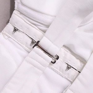 Close-up of the hook-and-eye metal closure and stitching on this white corset top