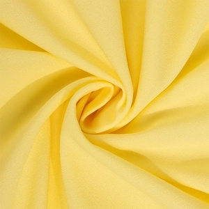 Detailed view of the bright yellow chiffon fabric showing soft drape and fine texture