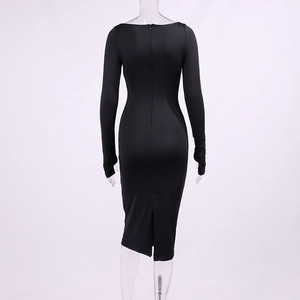Detail view of the black dress back featuring a hidden zipper and a centered hemline slit