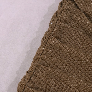 Close-up of brown sequined fabric texture with cowl neck ruched detailing and silver sparkles