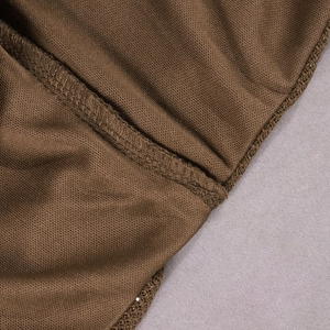 Detailed macro view of dark brown knit fabric with reinforced overlock stitching seams