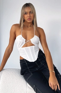 Detail of white mesh corset top with halter neck, criss-cross ties, and draped mesh texture