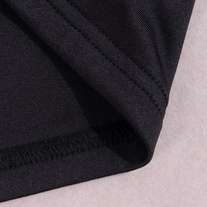 Detail shot of the double-needle stitching and hem on this black knit bodycon dress