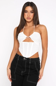 Close-up of white halter corset top with mesh ruching and lace-up front details