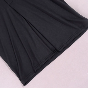 Detail of double-needle stitched hem on black dress with fine silk texture and pleats