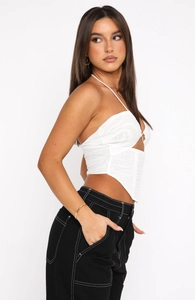 Detailed side view of a white halter neck corset top with ruched mesh and cross straps