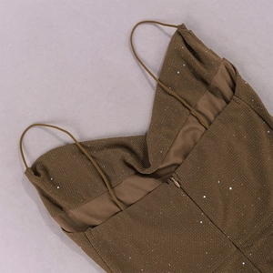 Macro view of brown sequin dress texture with slim strap and hidden zipper detail