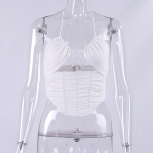 Detail of white halter neck top featuring intricate ruched mesh and lace-up neck design